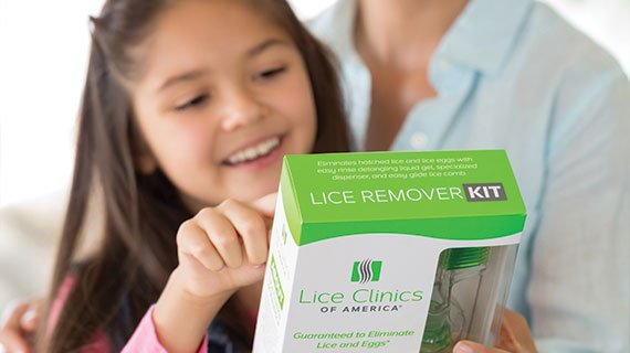 A mother and daughter reading the back of the LCA Lice remover kit