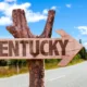 Sign on the side of the road with an arrow leading in the direction of Kentucky