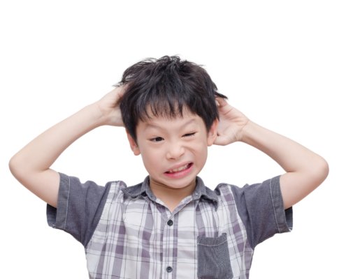Little boy scratching his head with both hands