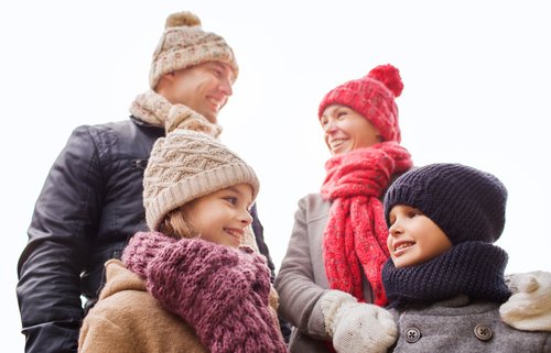 Mother, father, daughter, and son bundled up for the winter