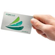 Hand holding out a CareCredit card